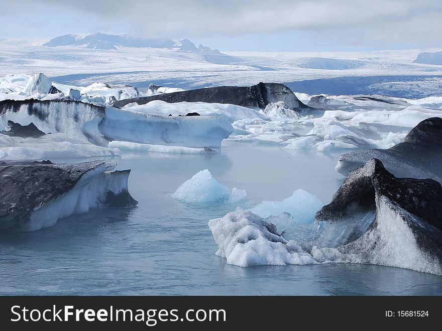 Icebergs floating in the glacial lagoon at JÃ¶kulsÃ¡rlÃ³n in Iceland