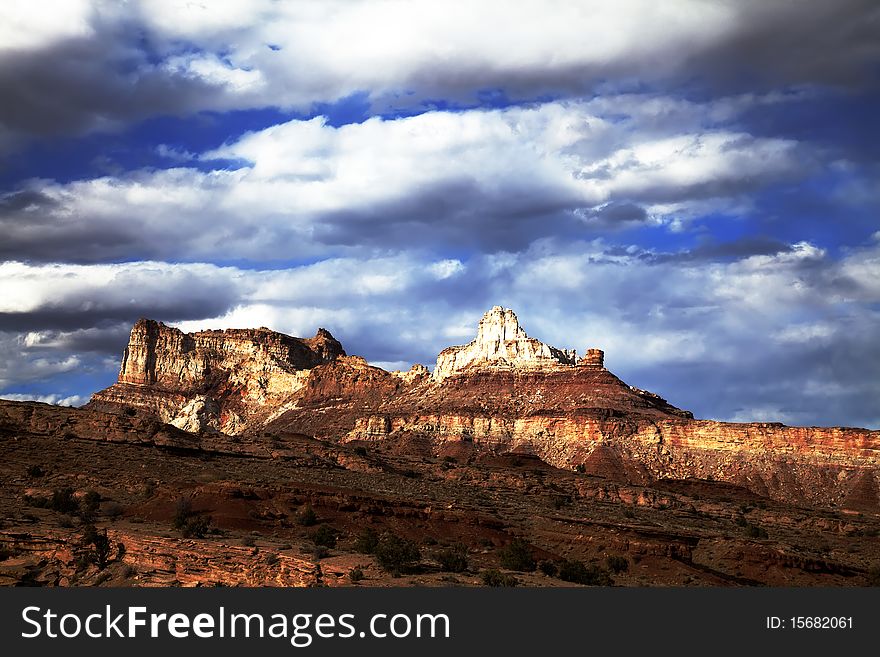 View of the red rock formations in San Rafael Swell with blue sky and clouds