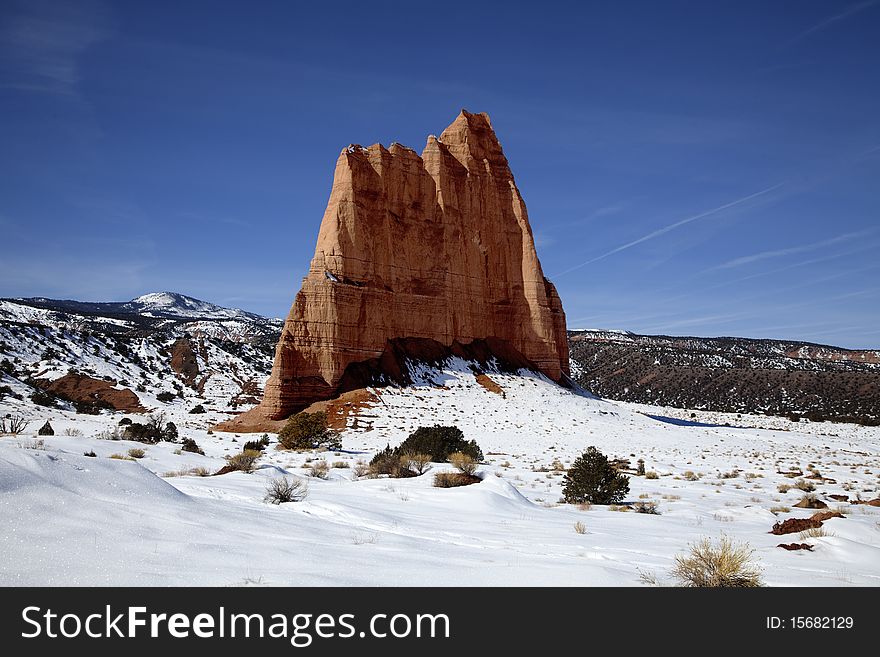View of the red rock formations in Capitol Reef National Park with blue skyï¿½s and clouds  and snow