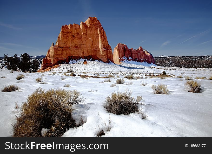 View of the red rock formations in Capitol Reef National Park with blue skyï¿½s and snow on the ground