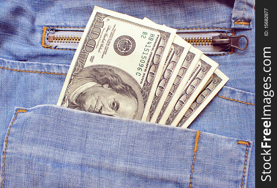 Blue jeans pocket with many one hundred dollars banknotes. Blue jeans pocket with many one hundred dollars banknotes