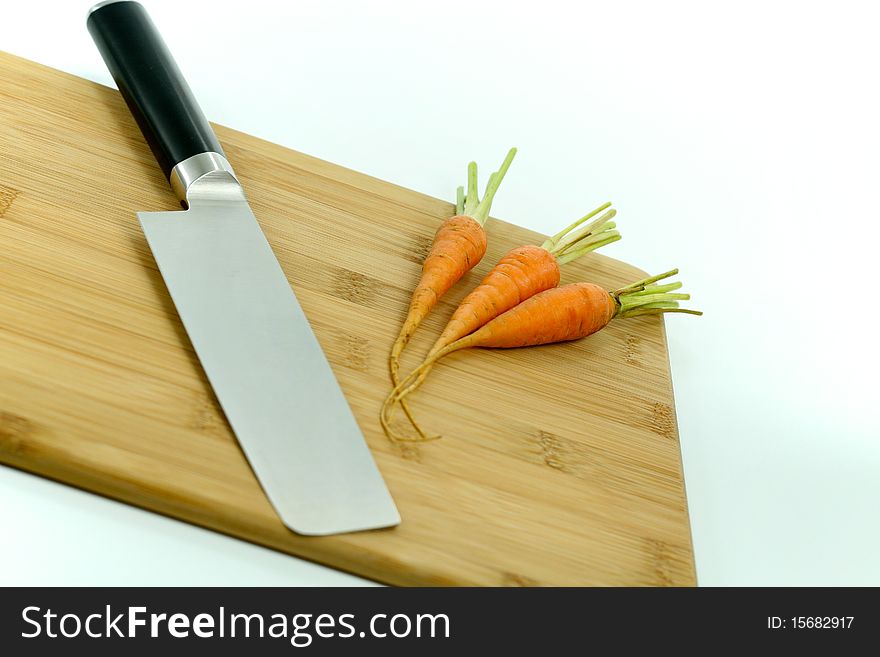 A picture of japanese knife and carrots