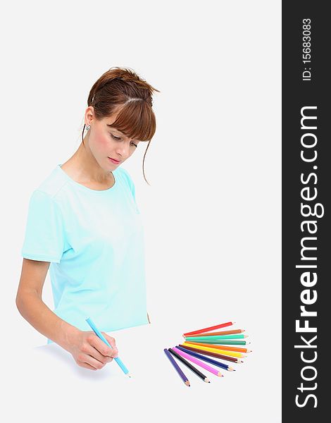 A woman drawings with colorful pencils isolated on a white background. A woman drawings with colorful pencils isolated on a white background