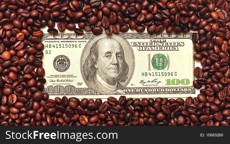 Dollar on amid scattered coffee beans packing dollars.