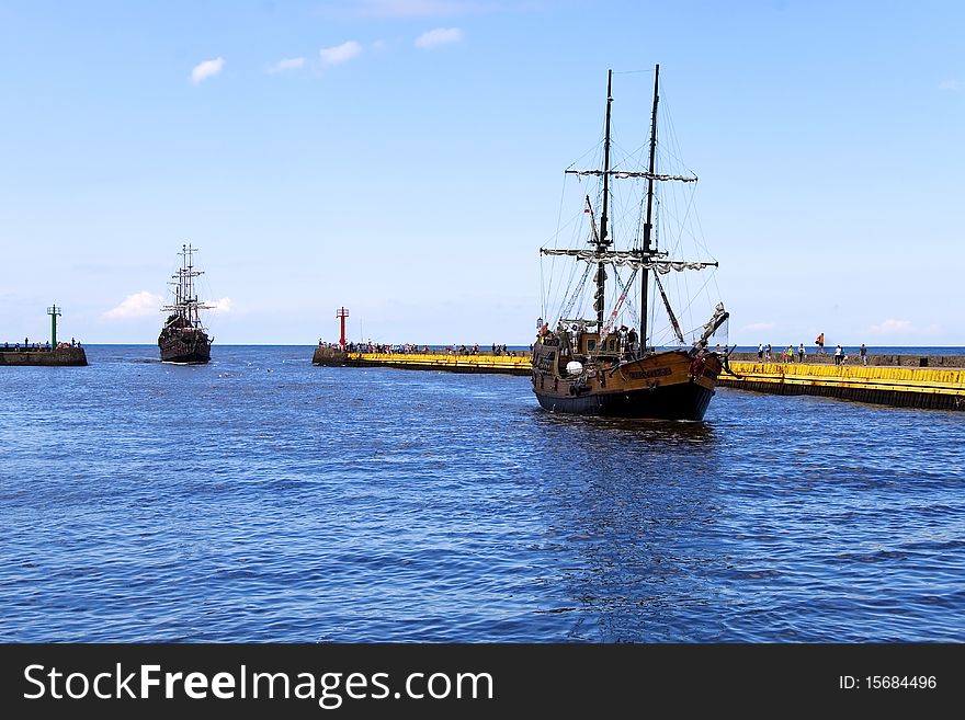 Sailing ship sailing into the port at sea. Sailing ship sailing into the port at sea