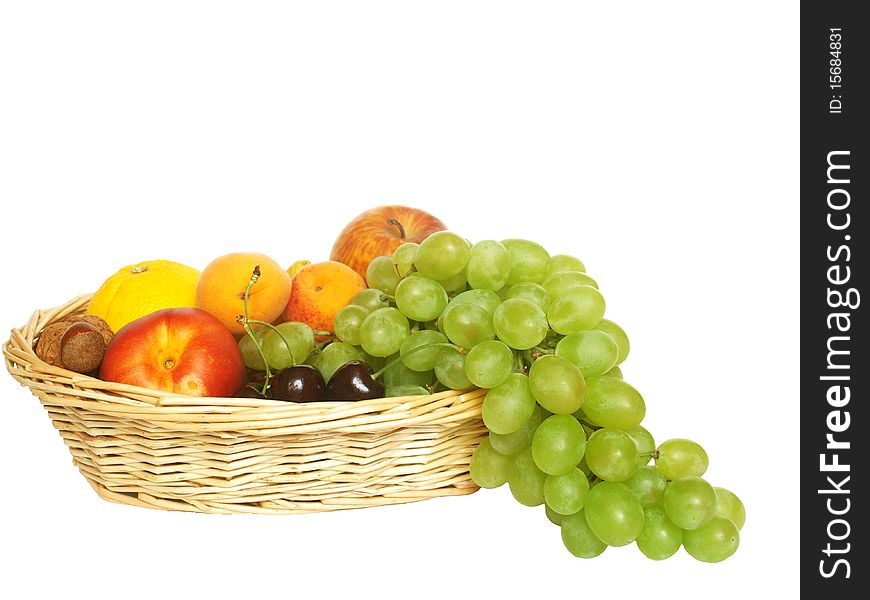 Various fruit in the basket on a white background