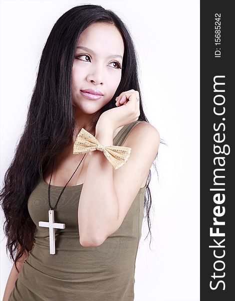 Young Chinese woman with long hair posing on white.