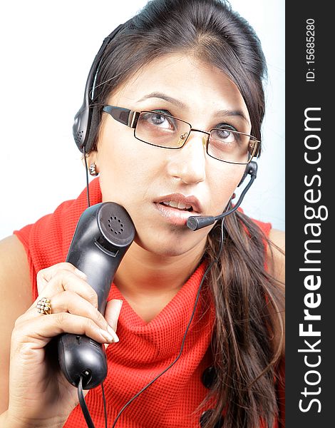 Busy call center executive on white background, asian woman.