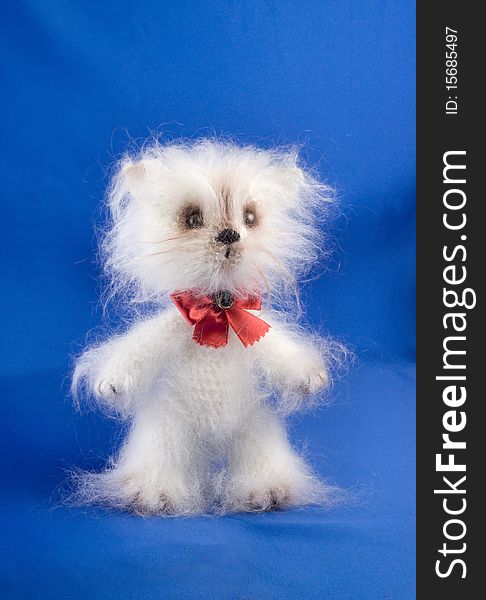 Soft toy cat handwork on a blue background