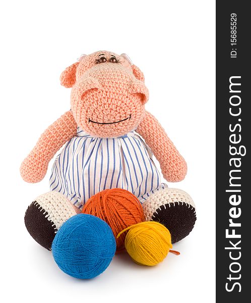 Soft toy hippopotamus and balls of thread handwork isolated on white background