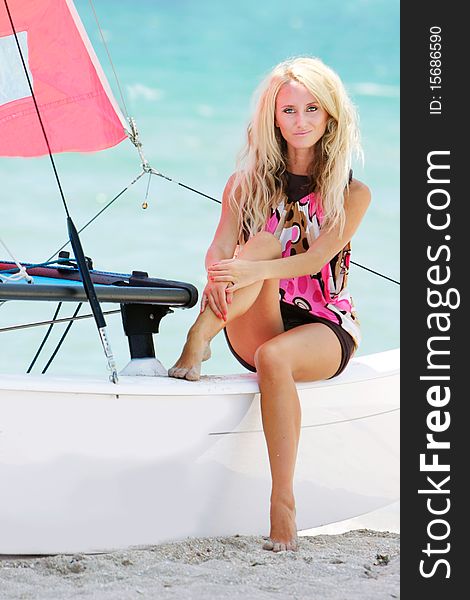Young attractive girl sitting on yacht