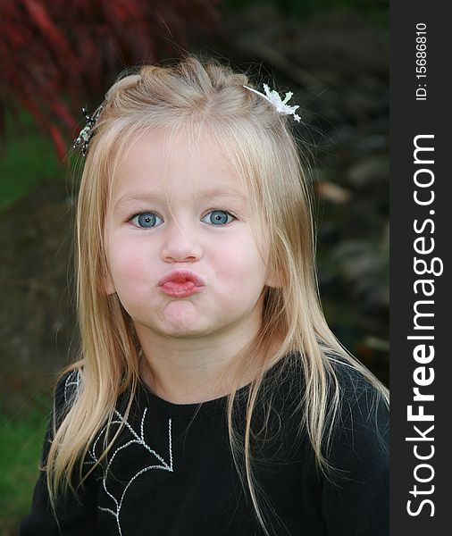 Young girl makes a silly kissy face