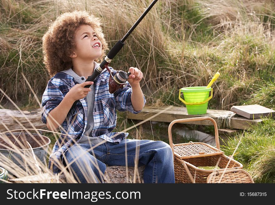 Young Boy Fishing At Seaside