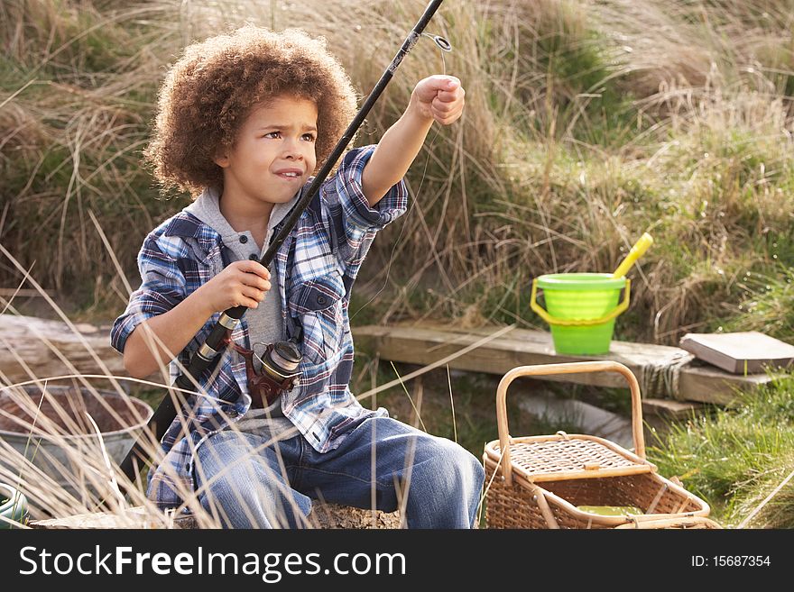 Young Boy Fishing At Seaside