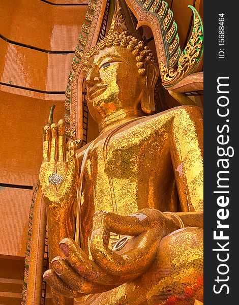 Golden big Buddha statue taken from low angle