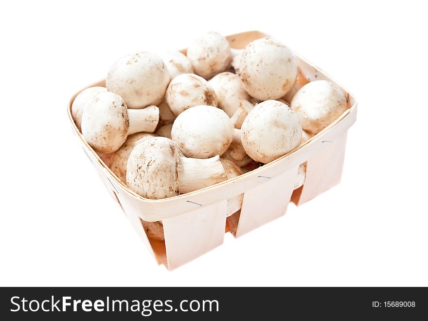 Raw mushrooms in box isolated on white background