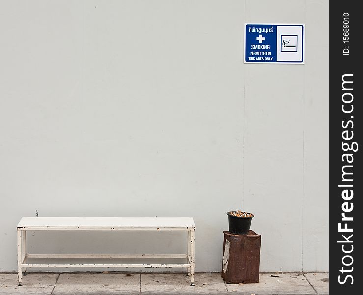 Bench in smoking area and sign