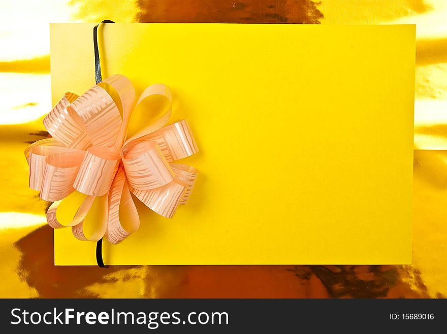 Yellow paper blank with bow on yellow background. Yellow paper blank with bow on yellow background