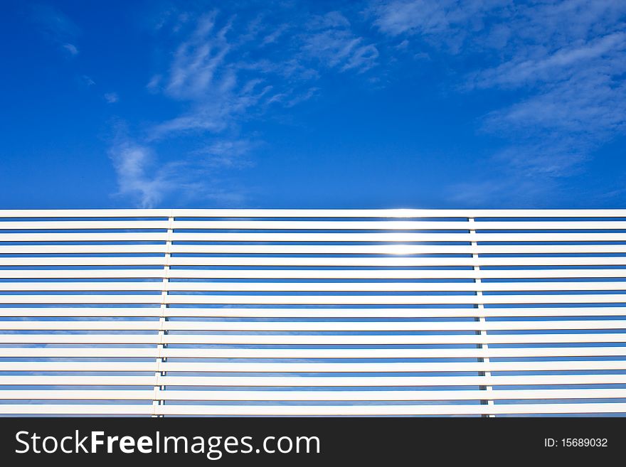 Metal Fence Lines And Blue Sky