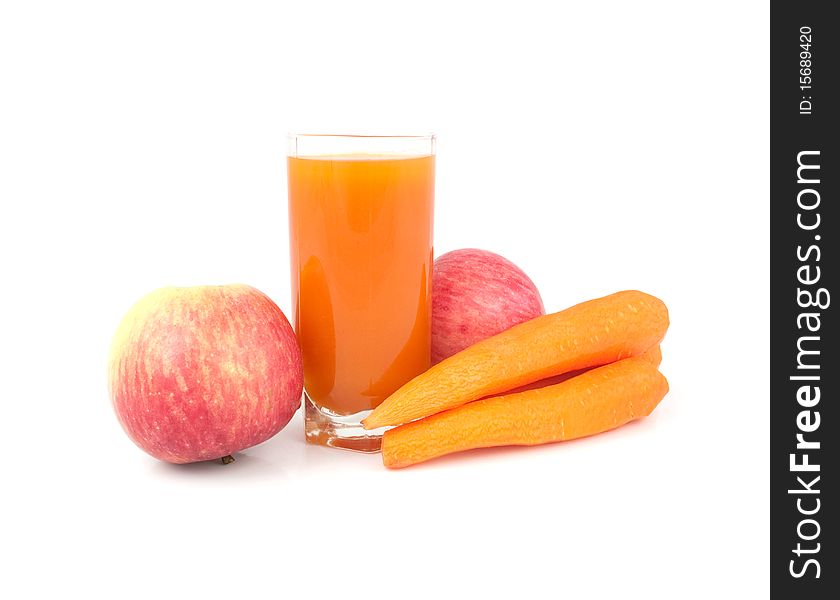 Glass of juice with carrots and apples on a white background