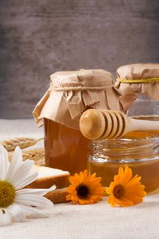Flowers And Honey On Table Stock Photo Flowers And Honey On Table Stock Photo