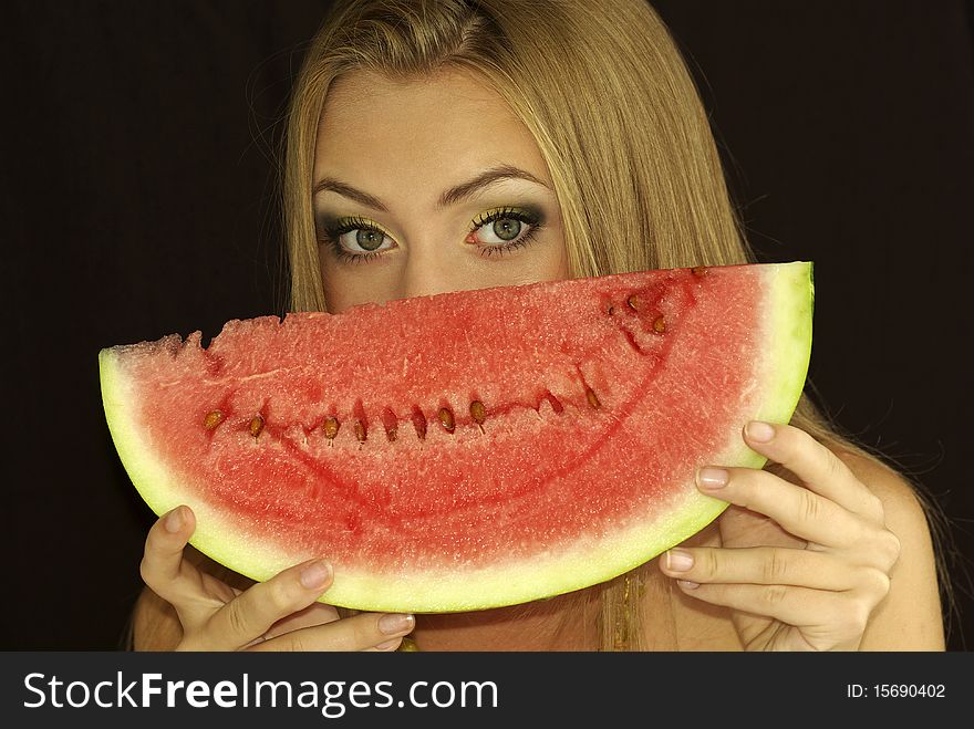 Portrait of a beautiful sexual girl with watermelon in his hands, isolation on a black background. Portrait of a beautiful sexual girl with watermelon in his hands, isolation on a black background