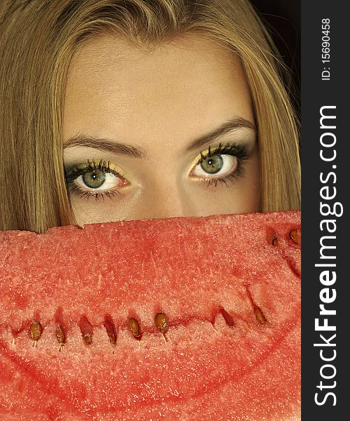 Portrait of a beautiful sexual girl with watermelon in his hands, isolation on a black background. Portrait of a beautiful sexual girl with watermelon in his hands, isolation on a black background