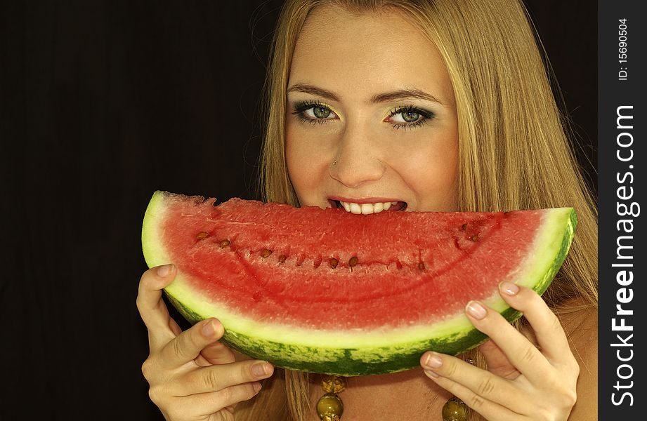 Portrait of a beautiful sexual girl with watermelon in his hands, isolation on a black background. Portrait of a beautiful sexual girl with watermelon in his hands, isolation on a black background