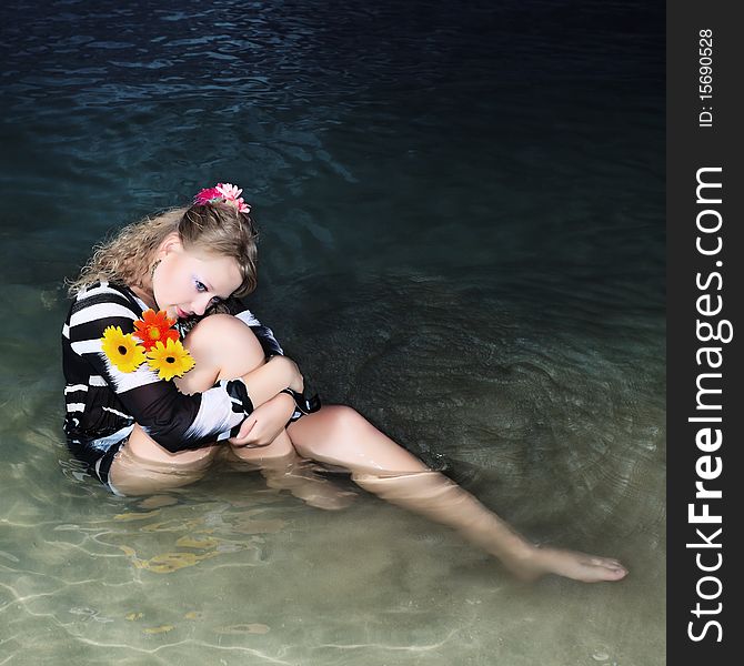 Beautiful woman with flowers in the sea. Beautiful woman with flowers in the sea