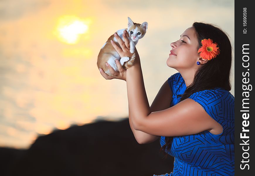 Woman with kitten outdoor at sunrise time. Woman with kitten outdoor at sunrise time