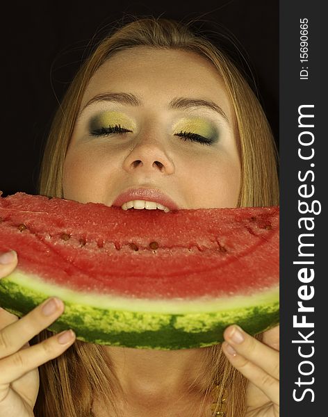 Portrait of a beautiful sexual girl with watermelon in his hands, isolation on a black background. Portrait of a beautiful sexual girl with watermelon in his hands, isolation on a black background