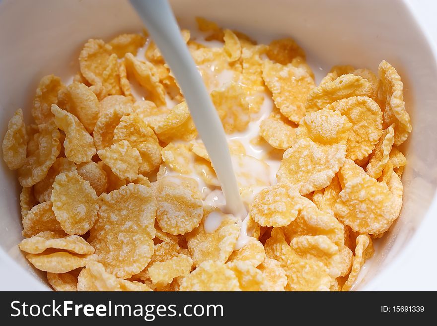 Corn flakes with milk in bowl