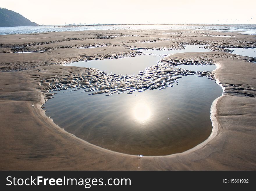 Magnificent sunset on the sand beach, India