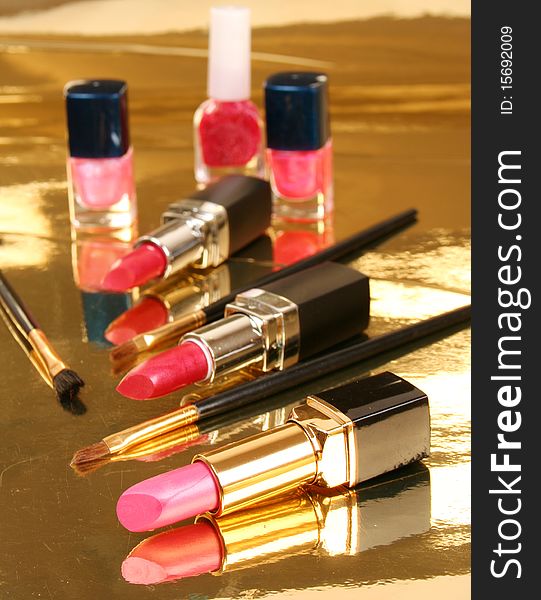 Decorative cosmetics on a gold background