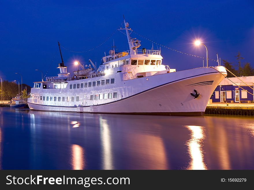 Passenger liner with night by the harbour in the port. Passenger liner with night by the harbour in the port