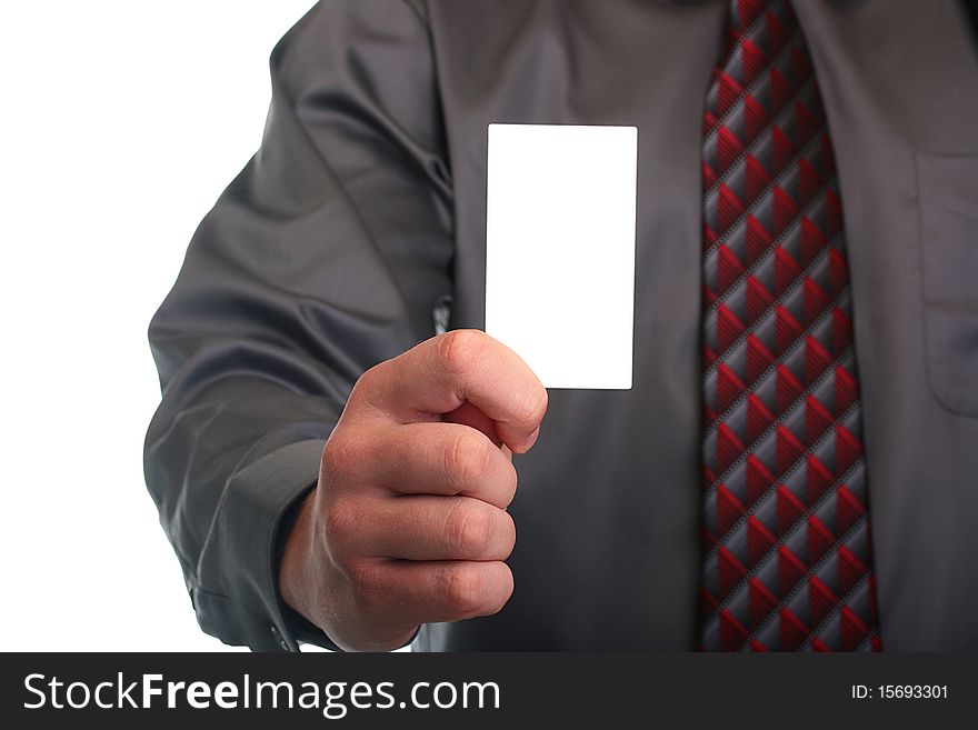 The businessman in a grey shirt and a tie stretches out a business card.