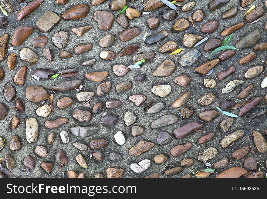 Surface texture of a concrete sidewalk with exposed aggregate. Surface texture of a concrete sidewalk with exposed aggregate