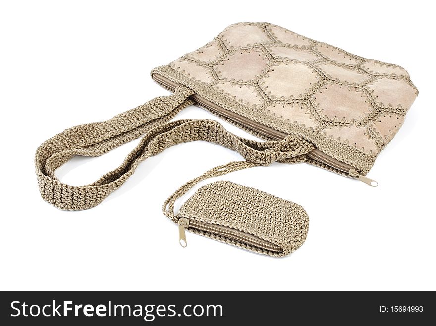 Beige leather bag with knitted elements and wallet. Isolated on white background. Beige leather bag with knitted elements and wallet. Isolated on white background