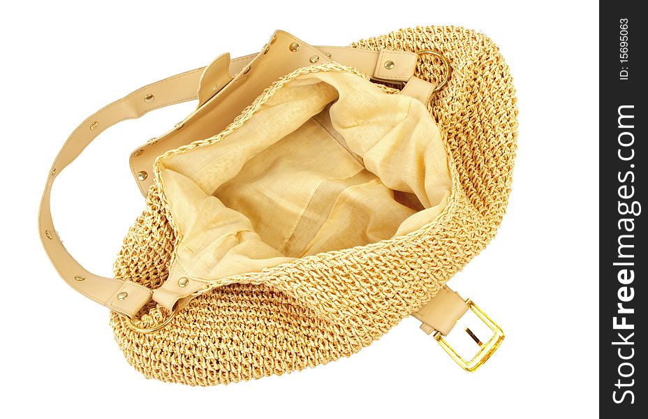 Golden female handbag with leather and textile elements. Isolated on white background. Golden female handbag with leather and textile elements. Isolated on white background