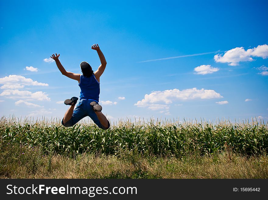 Man jumping in a corn field