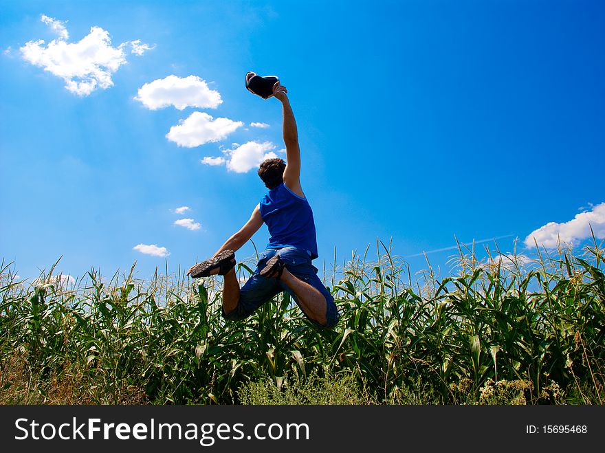 Man jumping in a corn field