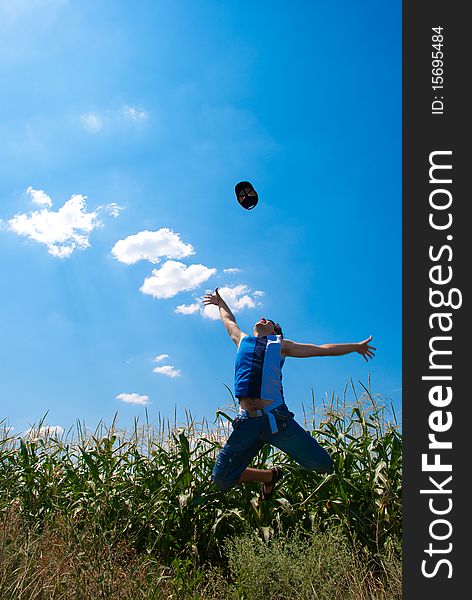 Man jumping in a corn field