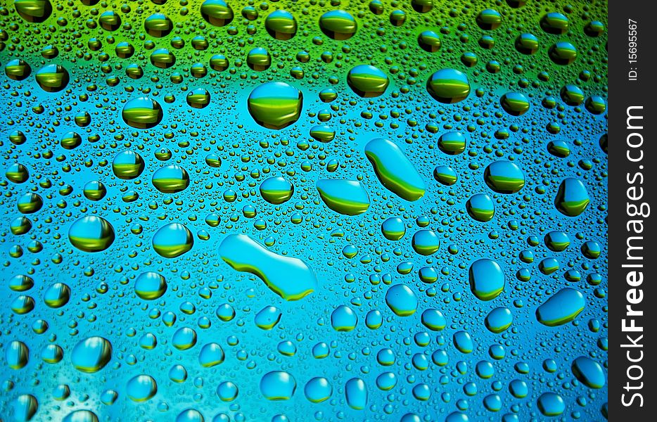 Many little water drops on the glass(yellow,blue). Many little water drops on the glass(yellow,blue)