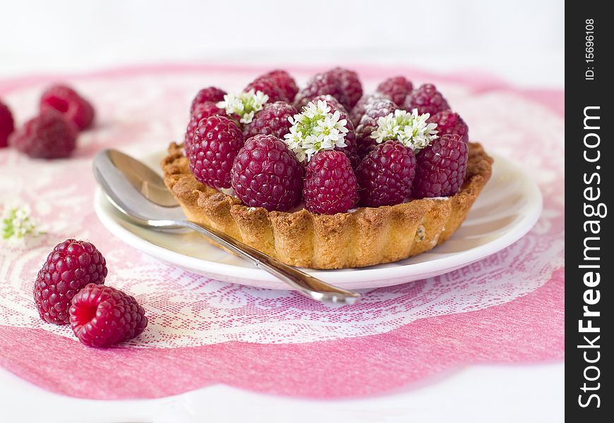 A fresh raspberry tart on a napkin