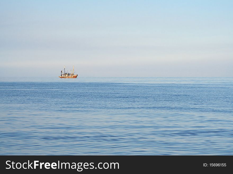 Fishing boats while fishing in the evening sea