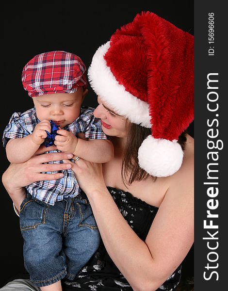 Beautiful christmas mother and son on a black background. Beautiful christmas mother and son on a black background