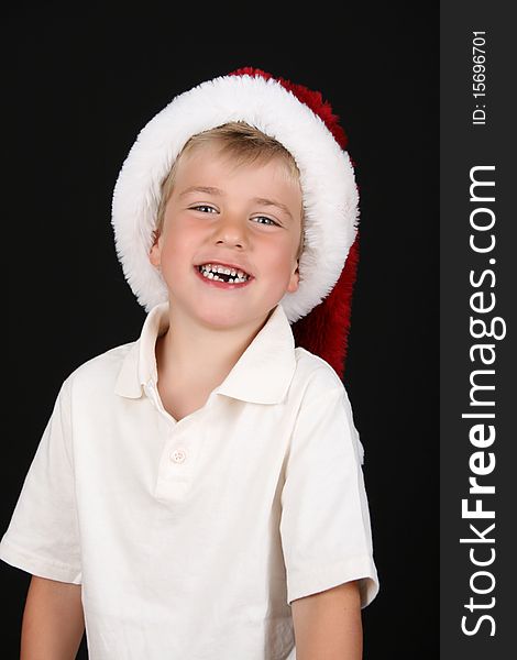 Cute young boy on a black background with a happy expression. Cute young boy on a black background with a happy expression