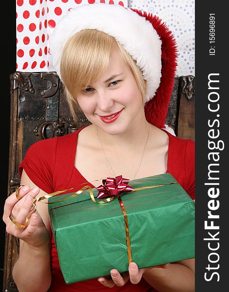 Beautiful blond female holding a christmas present. Beautiful blond female holding a christmas present