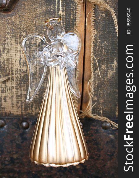 Golden glass angel against a rugged antique background. Golden glass angel against a rugged antique background