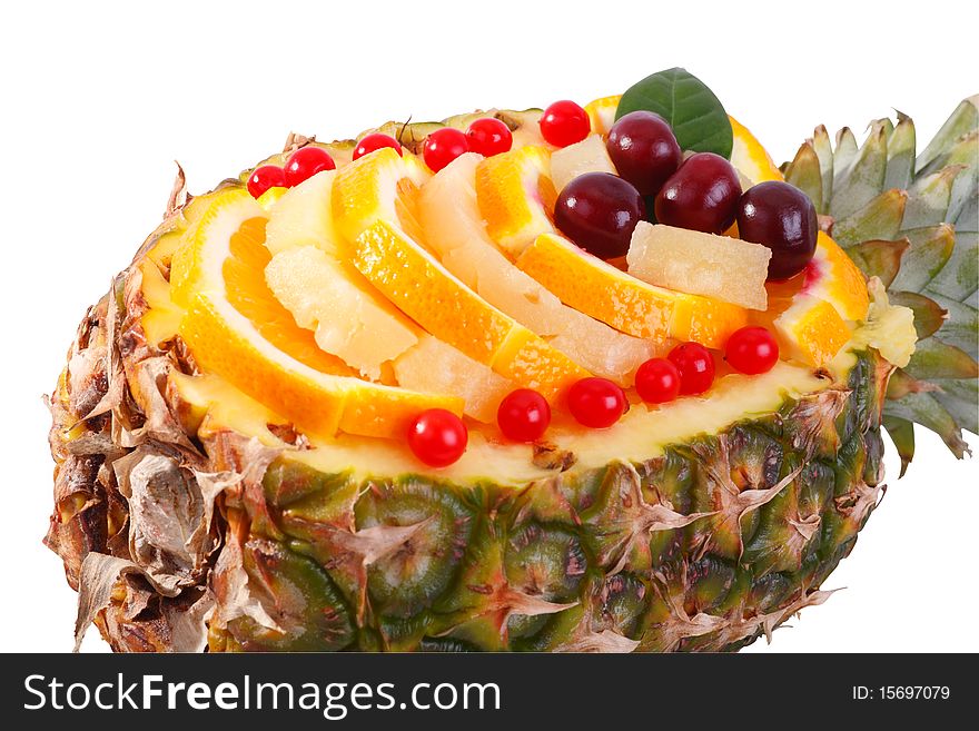 Fruit salad in Pineapple closeup. Isolated on white background
